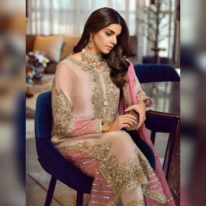Woman in a traditional outfit sitting on a chair indoors