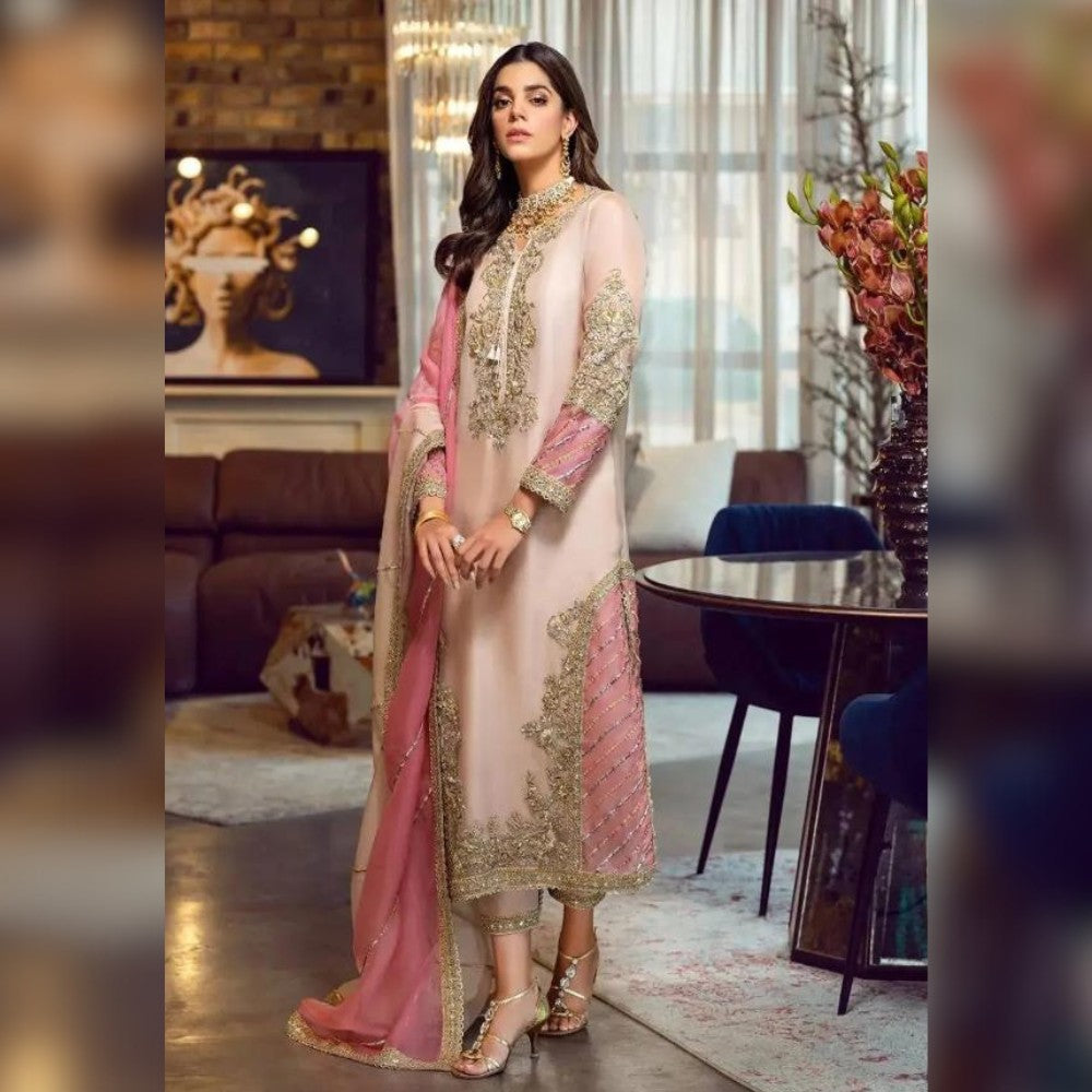 Woman in a traditional outfit standing in a stylishly decorated room.