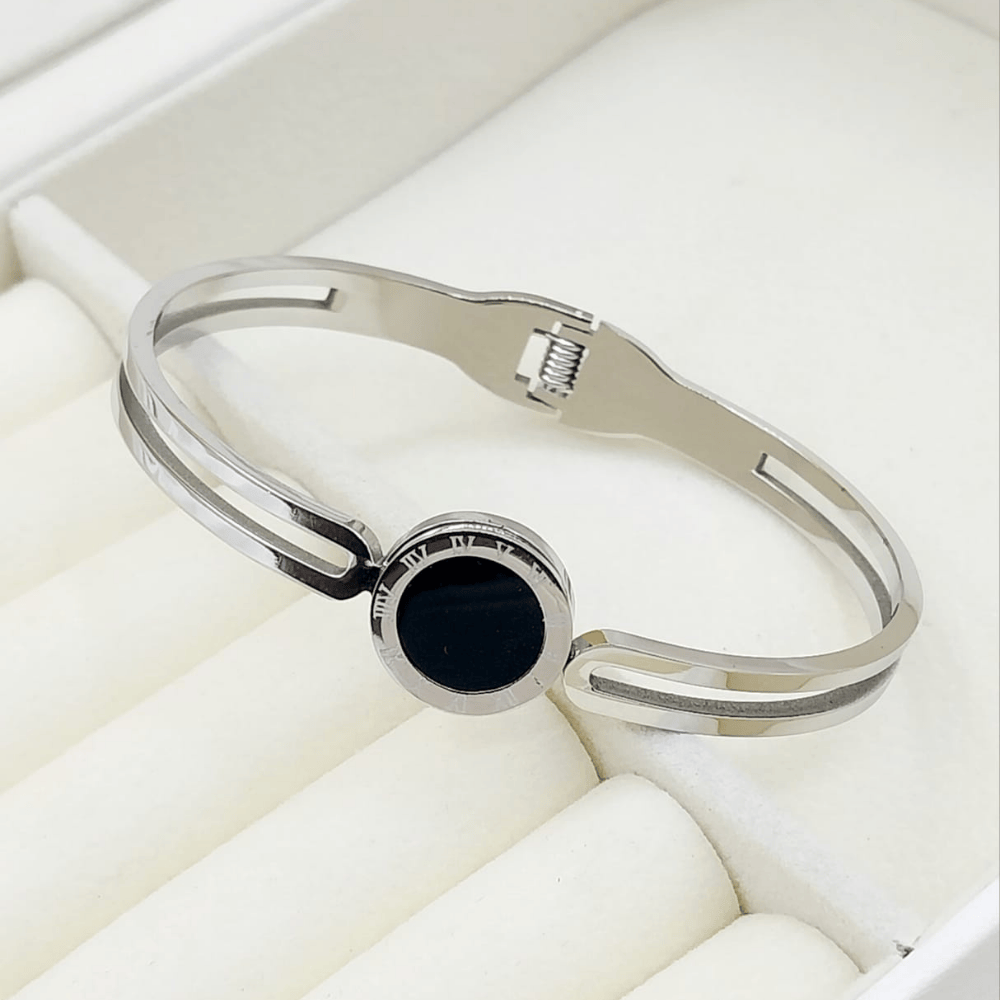 Gold artificial bangle with black stone in center