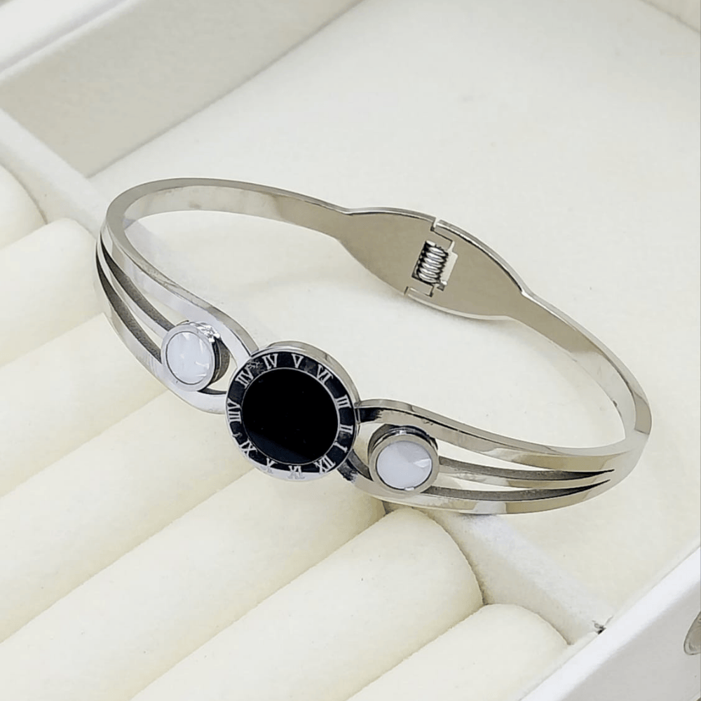 Silver bangle with central black stone and white accents