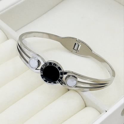 Silver bangle with central black stone and white accents