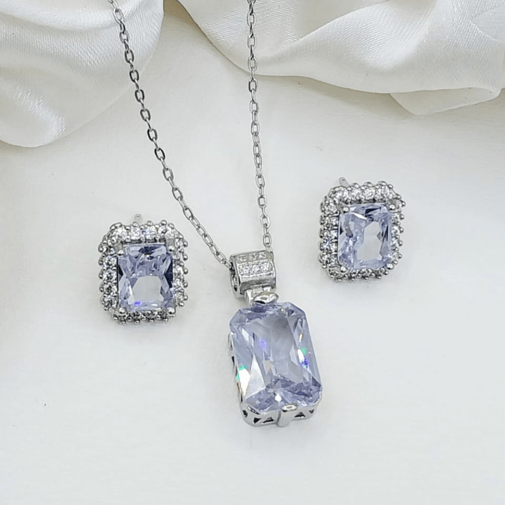 Silver-toned locket with matching earrings shown clearly from the front