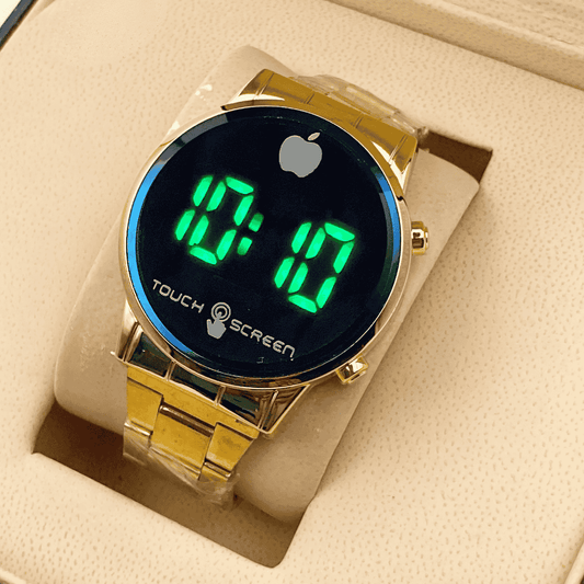 Gold digital watch with green LED display on a beige cushion