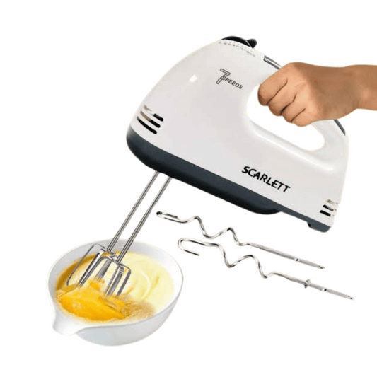 Hand mixer with attachments being used to mix ingredients in a bowl, on a white background.